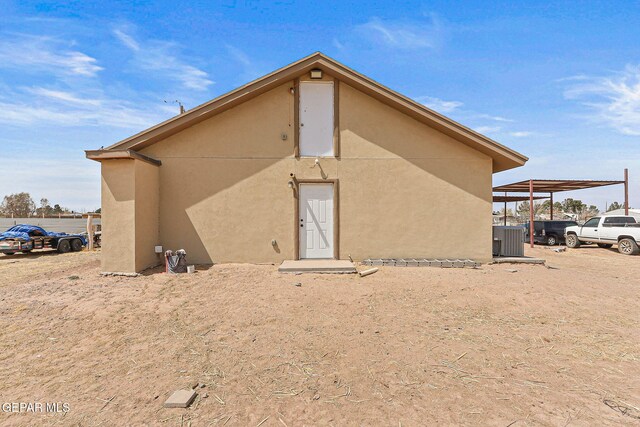 702 Thompson Rd, San Elizario, TX 79849 - rear view of property featuring central air condition unit and stucco siding
