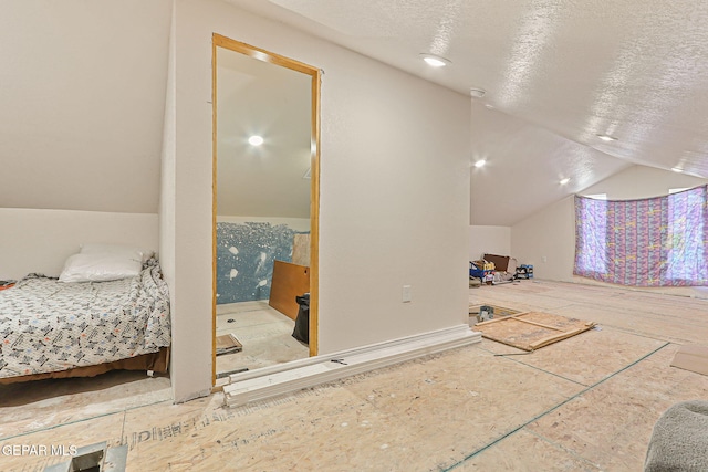 702 Thompson Rd, San Elizario, TX 79849 - bedroom featuring a textured ceiling and lofted ceiling