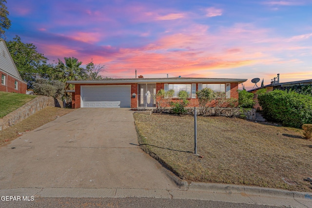 view of front of property with concrete driveway, brick siding, and an attached garage