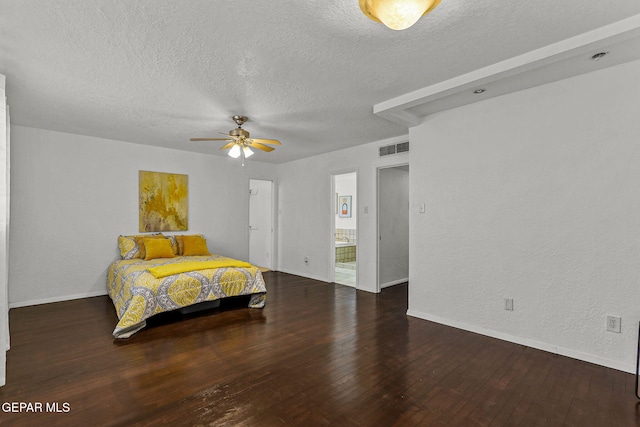 bedroom featuring visible vents, baseboards, hardwood / wood-style flooring, and a textured ceiling