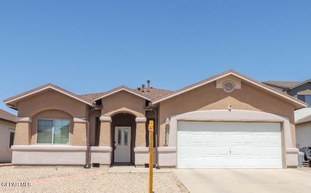 14325 Coyote Trl, El Paso, TX 79938 - ranch-style house with an attached garage, driveway, and stucco siding