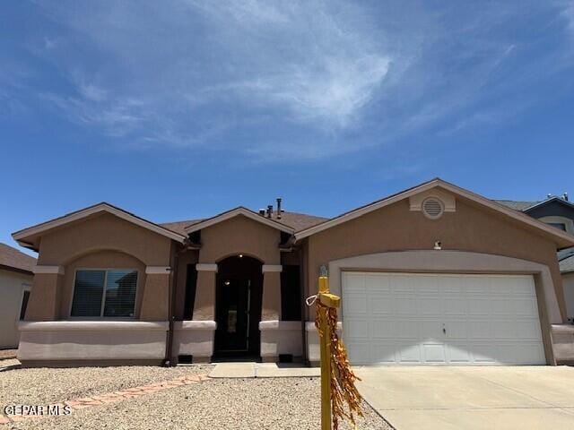 14325 Coyote Trl, El Paso, TX 79938 - ranch-style house with stucco siding, driveway, and an attached garage