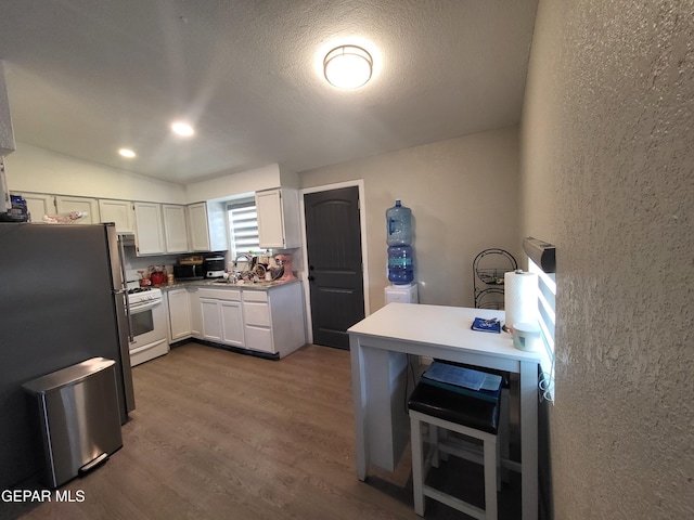 144 Marquita Ln, El Paso, TX 79915 - kitchen featuring white cabinets, a sink, a textured wall, white range with gas cooktop, and wood finished floors