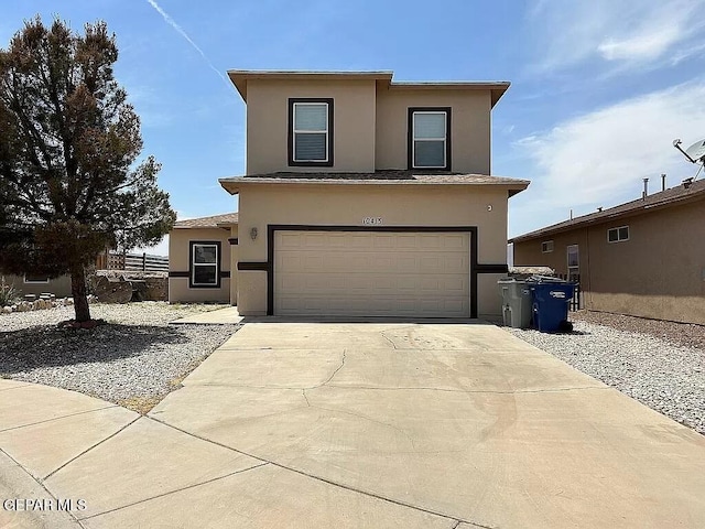 traditional-style home with an attached garage, concrete driveway, and stucco siding