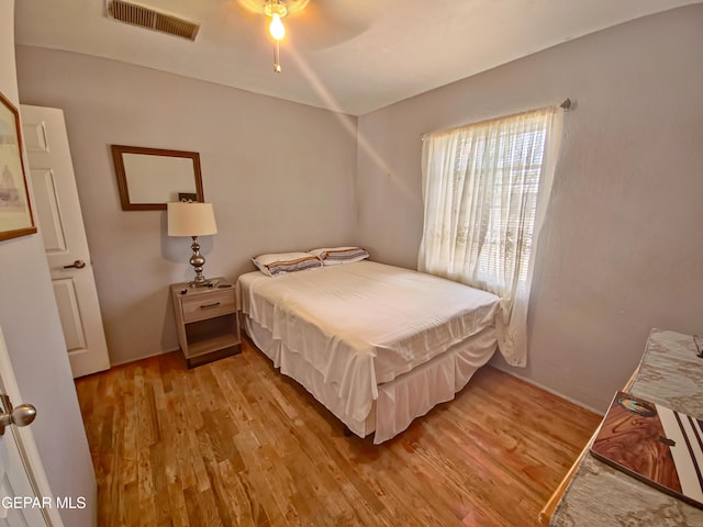 7726 Monterrey Dr, El Paso, TX 79915 - bedroom featuring visible vents and wood finished floors