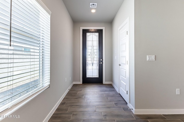 doorway with recessed lighting, visible vents, baseboards, and dark wood-style floors