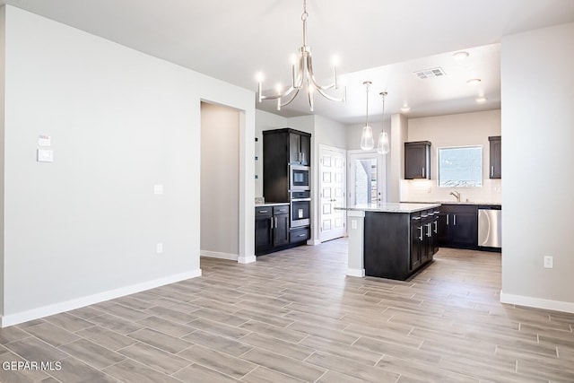 kitchen featuring light wood-style floors, visible vents, appliances with stainless steel finishes, baseboards, and a notable chandelier