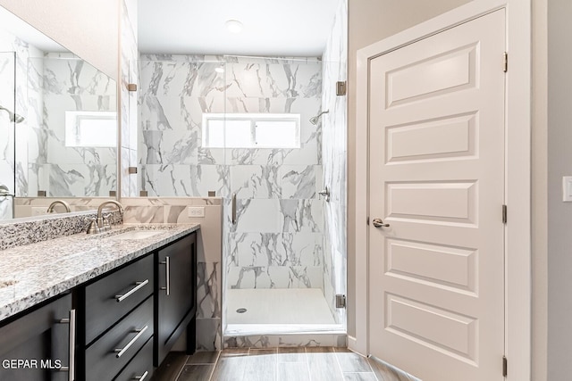 full bathroom with vanity and a marble finish shower