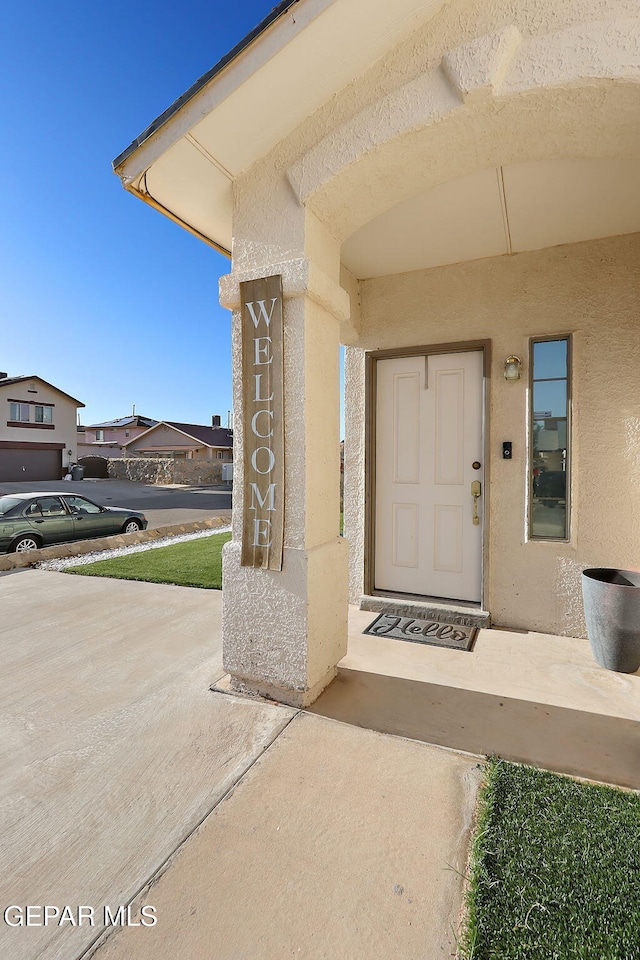 entrance to property with stucco siding