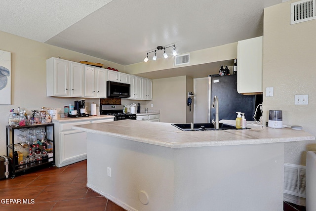 kitchen with stainless steel appliances, a sink, white cabinetry, a peninsula, and light countertops