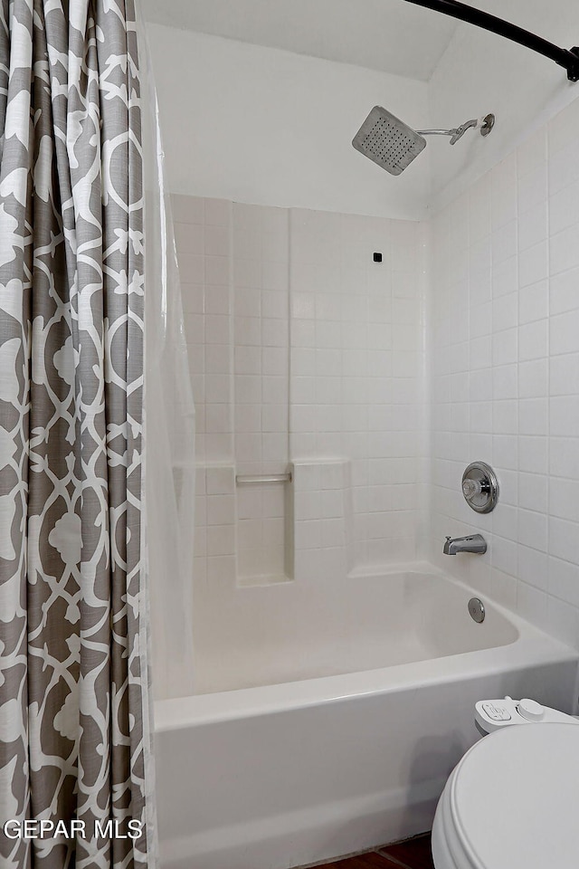 full bathroom featuring shower / bathtub combination with curtain and toilet