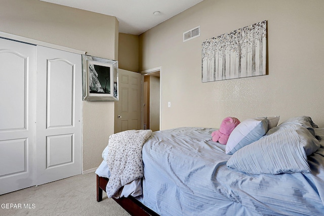bedroom featuring carpet and a closet
