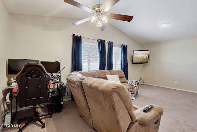 living area with carpet floors, ceiling fan, vaulted ceiling, baseboards, and a desk