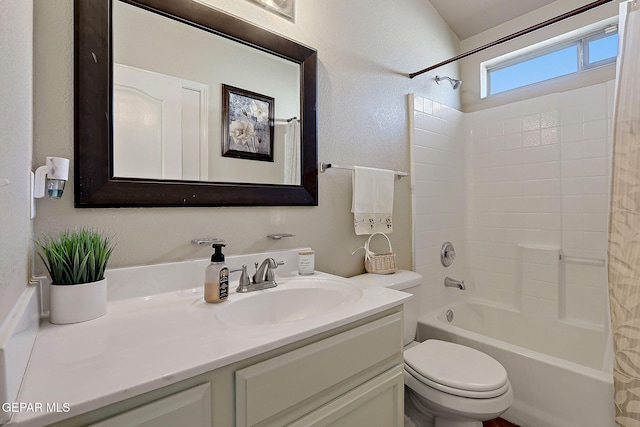 bathroom with shower / bath combination with curtain, vanity, toilet, and a textured wall