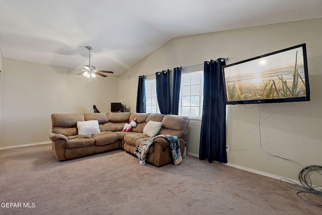 living room featuring carpet, ceiling fan, vaulted ceiling, and baseboards