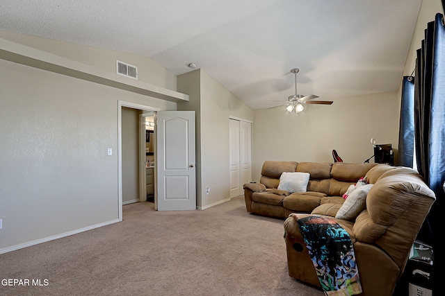 living area featuring vaulted ceiling, ceiling fan, light carpet, and baseboards