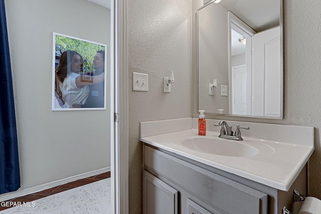 bathroom featuring tile patterned flooring and vanity