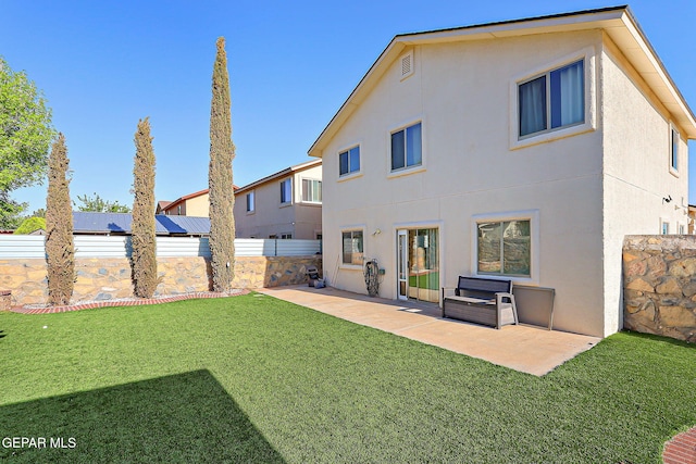 back of property with stucco siding and a patio area
