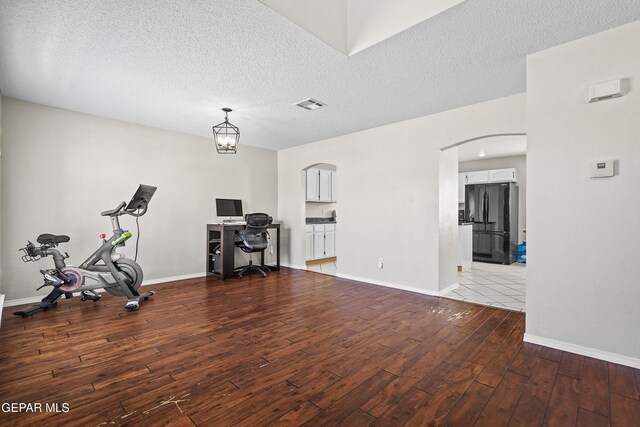 3501 Al Roberts Dr, El Paso, TX 79936 - interior space with arched walkways, wood finished floors, baseboards, and visible vents