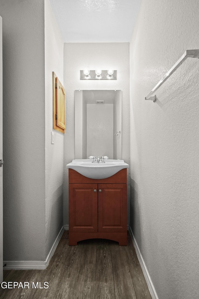 3501 Al Roberts Dr, El Paso, TX 79936 - bathroom featuring a textured wall, vanity, baseboards, and wood finished floors
