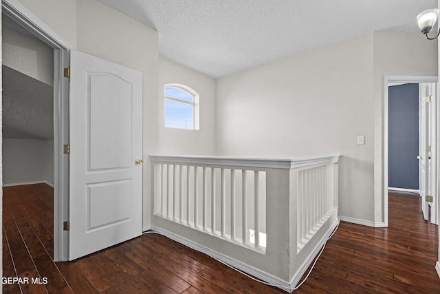 3501 Al Roberts Dr, El Paso, TX 79936 - corridor featuring dark wood-type flooring, a textured ceiling, and baseboards