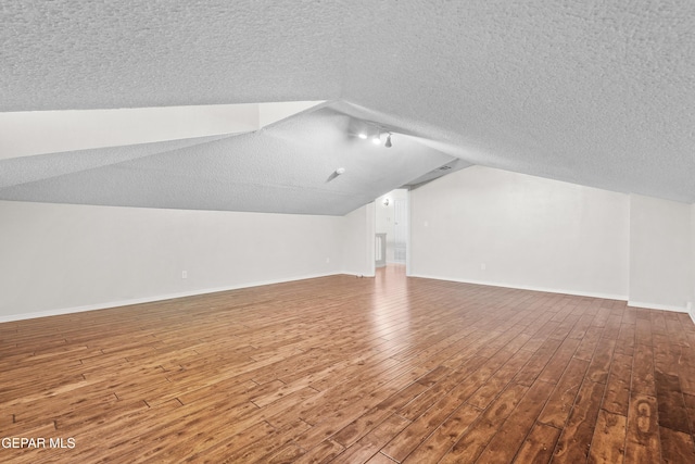 3501 Al Roberts Dr, El Paso, TX 79936 - additional living space featuring baseboards, lofted ceiling, wood finished floors, and a textured ceiling