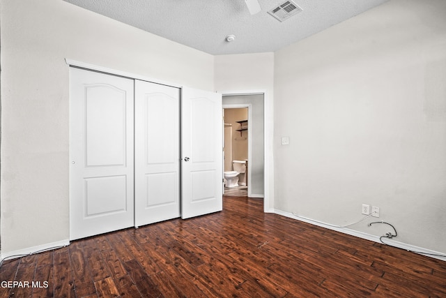 3501 Al Roberts Dr, El Paso, TX 79936 - unfurnished bedroom with a closet, baseboards, a textured ceiling, dark wood-type flooring, and visible vents