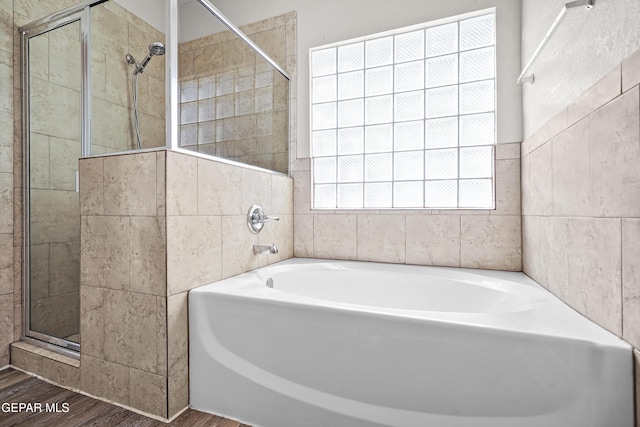 3501 Al Roberts Dr, El Paso, TX 79936 - full bathroom with a shower stall, tile walls, a garden tub, and wood finished floors