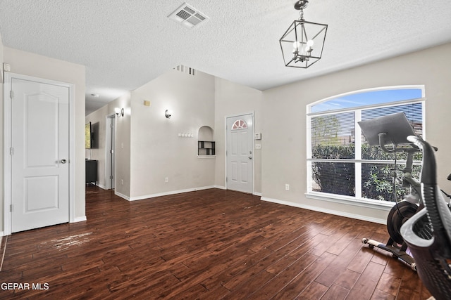 3501 Al Roberts Dr, El Paso, TX 79936 - interior space featuring baseboards, a chandelier, a textured ceiling, visible vents, and wood finished floors