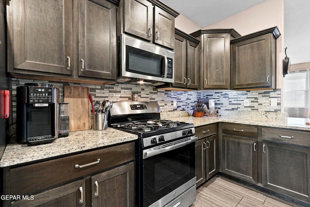 14439 Eastbrook Dr, El Paso, TX 79938 - kitchen featuring tasteful backsplash, dark brown cabinetry, light stone countertops, and stainless steel appliances