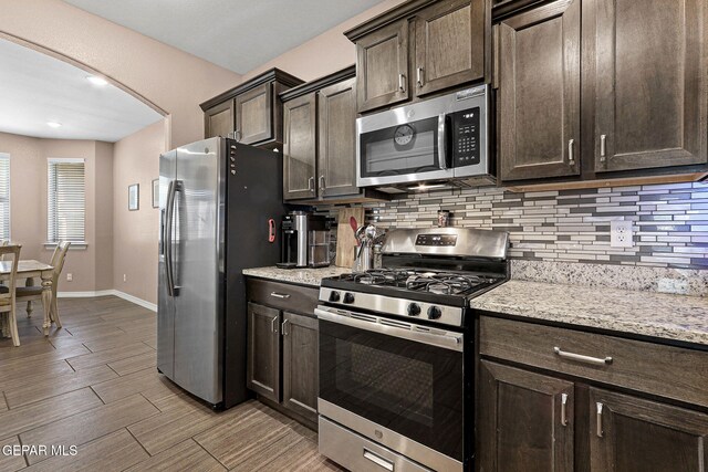 14439 Eastbrook Dr, El Paso, TX 79938 - kitchen featuring baseboards, backsplash, dark brown cabinets, and stainless steel appliances