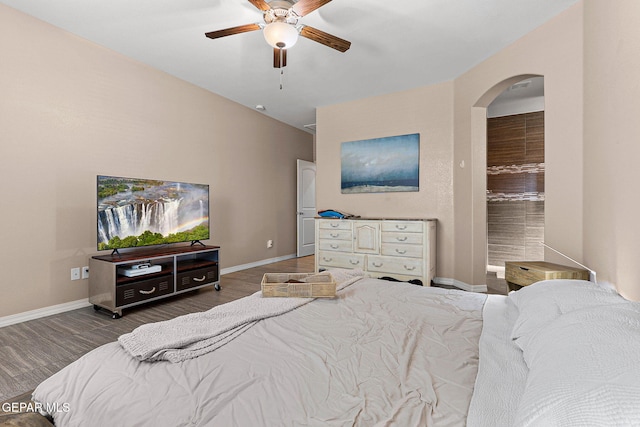 14439 Eastbrook Dr, El Paso, TX 79938 - bedroom with baseboards, arched walkways, ceiling fan, and wood finished floors