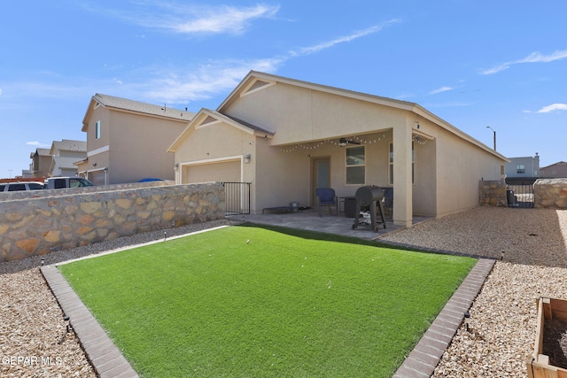 14439 Eastbrook Dr, El Paso, TX 79938 - back of property with a fenced backyard, stucco siding, a patio, a gate, and a garage