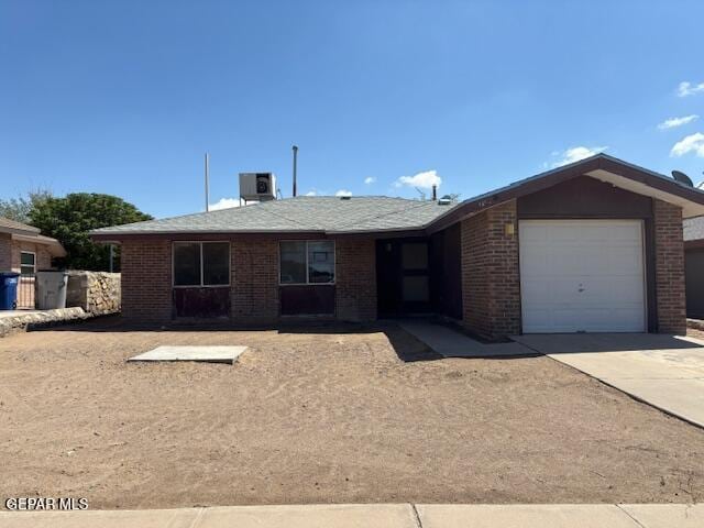 1562 Diego Rivera Dr, El Paso, TX 79936 - ranch-style home featuring an attached garage, driveway, brick siding, and cooling unit
