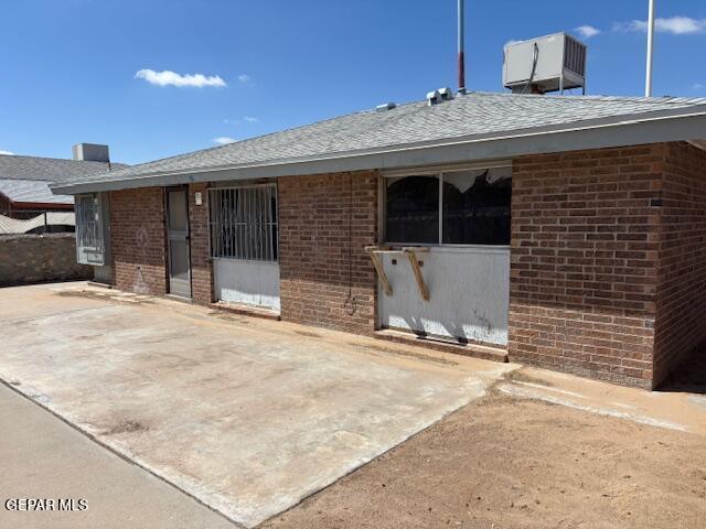 1562 Diego Rivera Dr, El Paso, TX 79936 - view of exterior entry with brick siding and roof with shingles