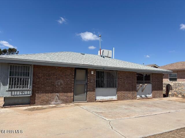 1562 Diego Rivera Dr, El Paso, TX 79936 - back of property featuring brick siding and roof with shingles