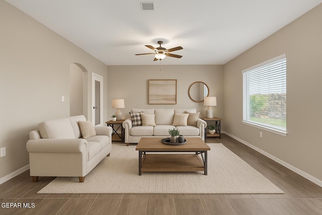 3600 Essence St, El Paso, TX 79938 - living area featuring a ceiling fan, arched walkways, baseboards, and wood finished floors