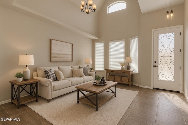 3600 Essence St, El Paso, TX 79938 - living area featuring a chandelier, baseboards, and high vaulted ceiling