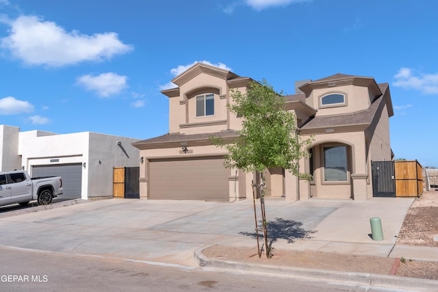 3600 Essence St, El Paso, TX 79938 - view of front of home with a gate, stucco siding, driveway, and a garage