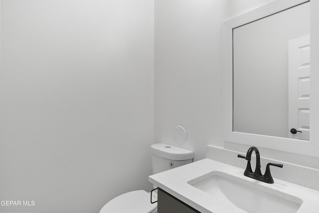 bathroom featuring toilet and vanity