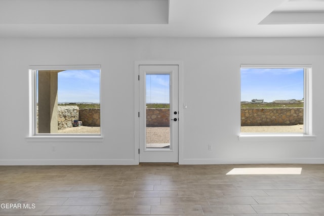 interior space featuring baseboards and wood finished floors