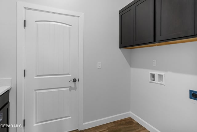 washroom featuring dark wood finished floors, electric dryer hookup, washer hookup, baseboards, and cabinet space