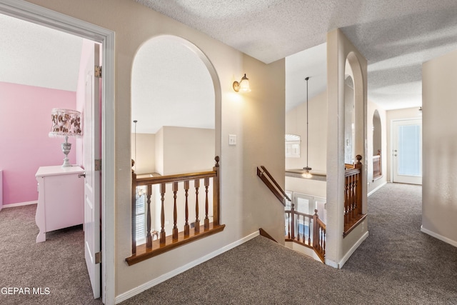 400 Rio Fango, El Paso, TX 79932 - corridor featuring carpet floors, an upstairs landing, arched walkways, and a textured ceiling