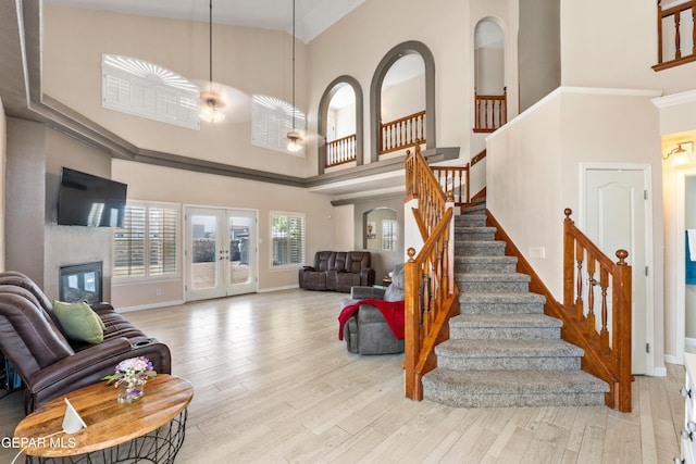 400 Rio Fango, El Paso, TX 79932 - living room featuring stairway, a high ceiling, and wood finished floors