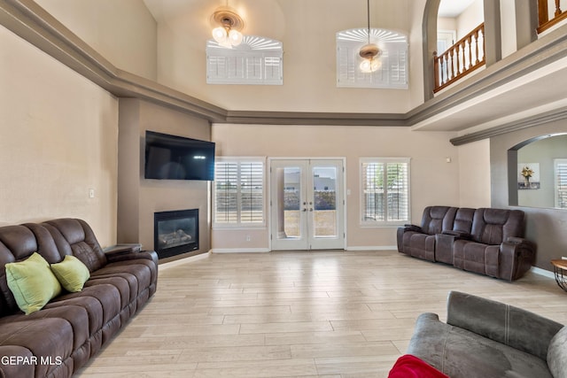 400 Rio Fango, El Paso, TX 79932 - living area with baseboards, french doors, a high ceiling, arched walkways, and wood finished floors