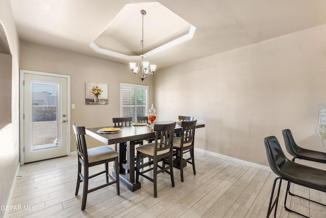 400 Rio Fango, El Paso, TX 79932 - dining room featuring a tray ceiling, a notable chandelier, light wood-type flooring, and baseboards