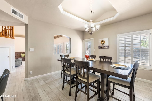 400 Rio Fango, El Paso, TX 79932 - dining space with visible vents, light wood-style flooring, arched walkways, and a tray ceiling
