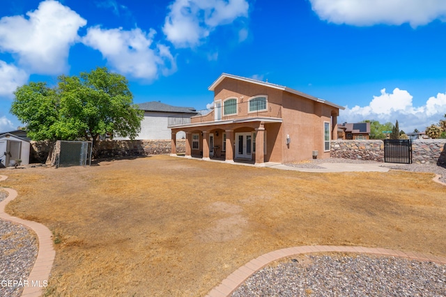 400 Rio Fango, El Paso, TX 79932 - rear view of property featuring a balcony, stucco siding, french doors, an outbuilding, and a storage unit
