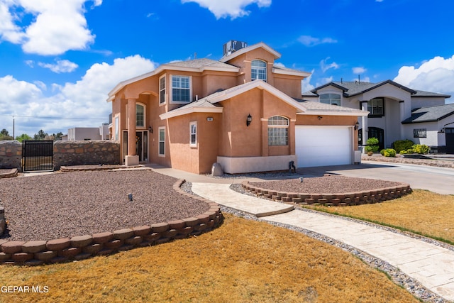 400 Rio Fango, El Paso, TX 79932 - mediterranean / spanish-style house with a garage, stucco siding, fence, a gate, and concrete driveway