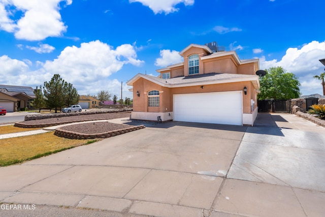 400 Rio Fango, El Paso, TX 79932 - traditional home with concrete driveway, stucco siding, a gate, a garage, and fence